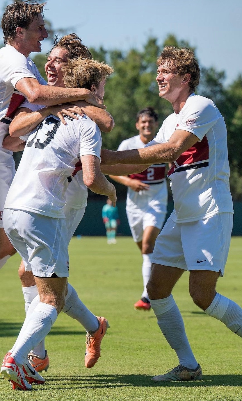 Soccer players celebrating together on the field